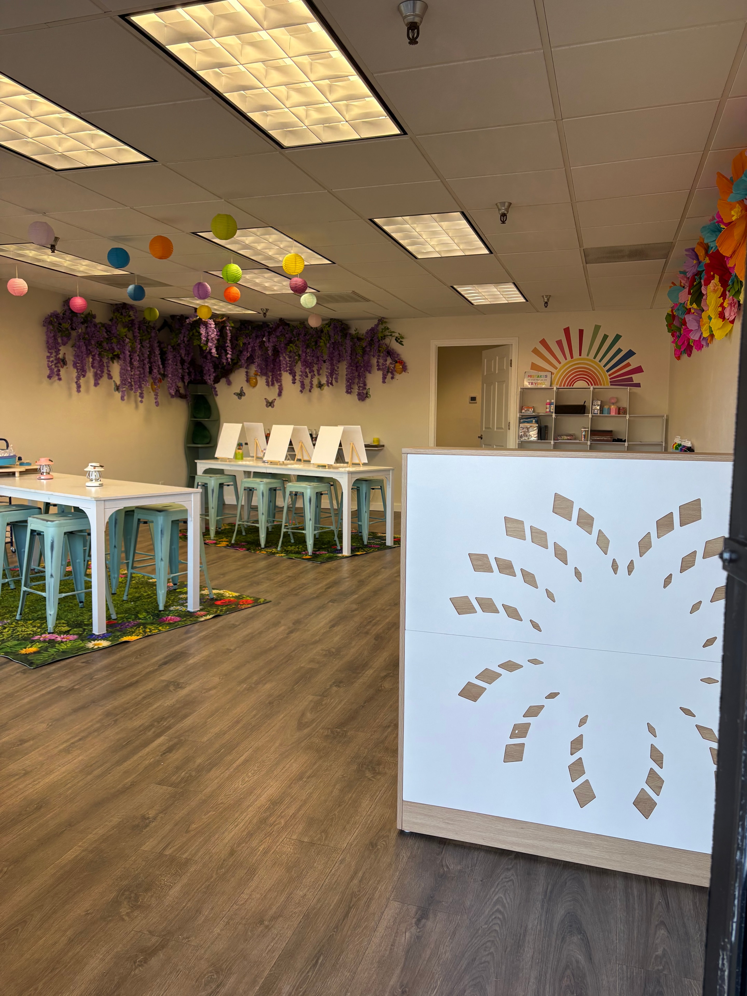 Studio with projection screen, colorful lanterns, and wisteria tree wall